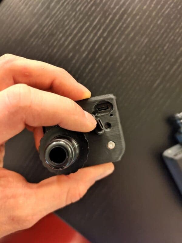 Close-up of the Aquator's USB-C charging port and hose fitting
