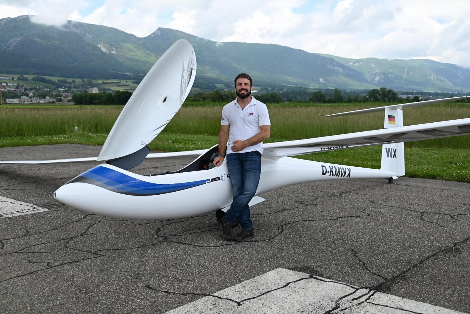 Pilot neben einem JS-Hochleistungs-Segelflugzeug auf einem Flugplatz