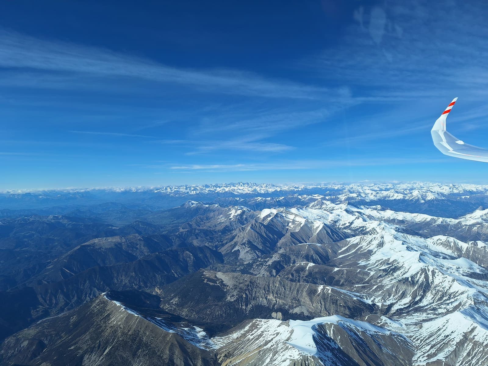 Snow-covered southern Alps under the glider wing on the way home to Saint-Auban