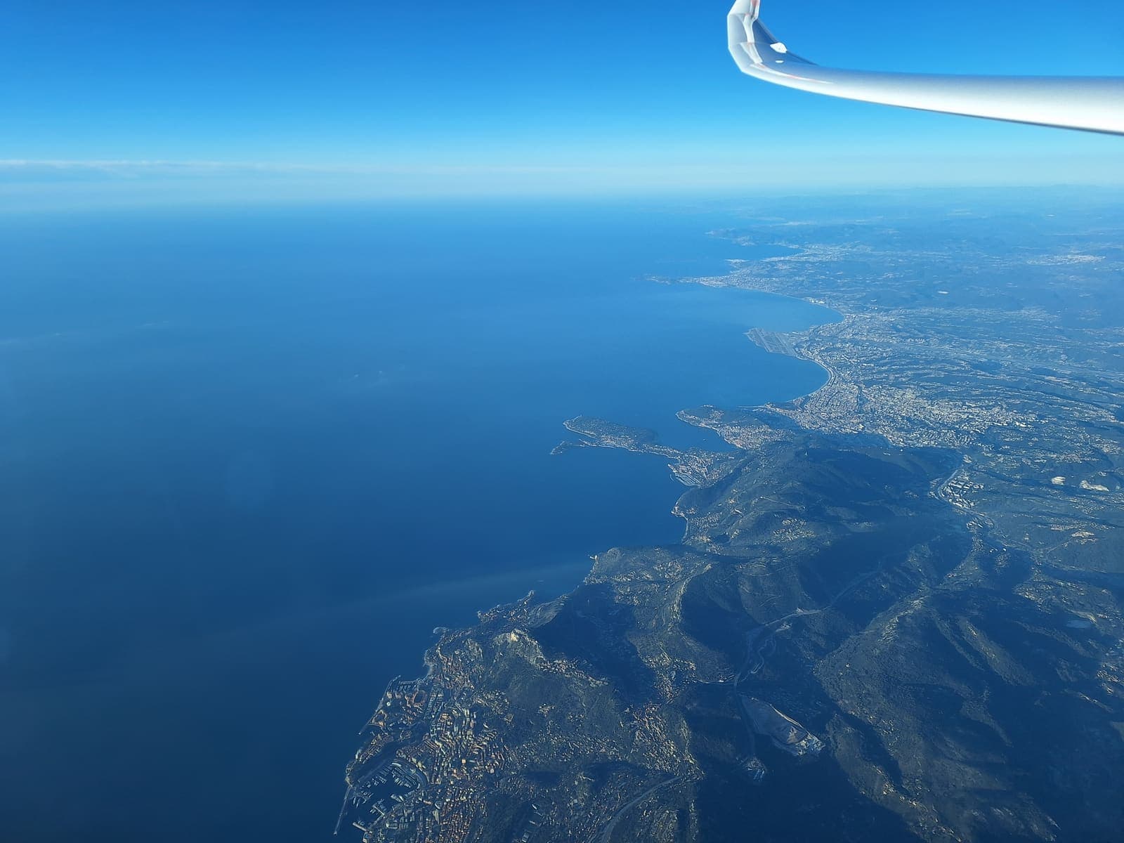 The French Riviera coastline far below the glider wing when leaving the mainland