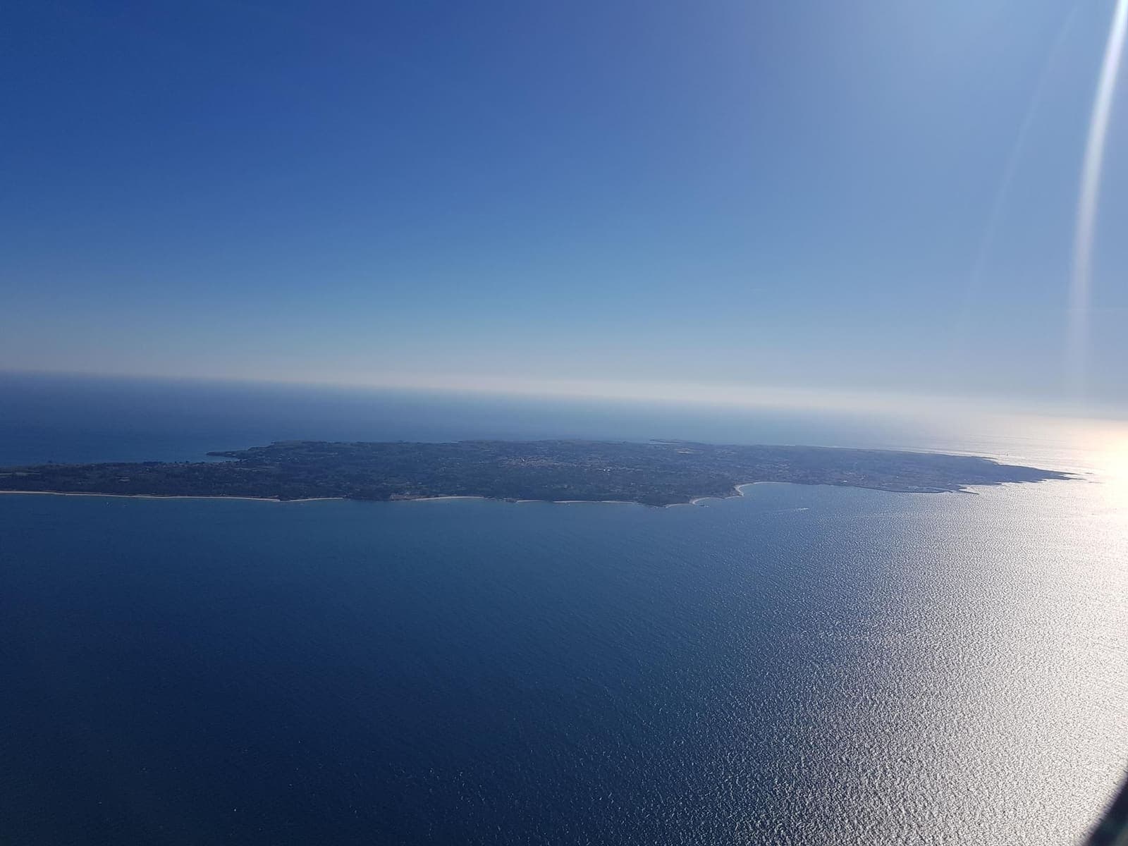 Île-d'Yeu as a thin silhouette on the glittering Atlantic horizon